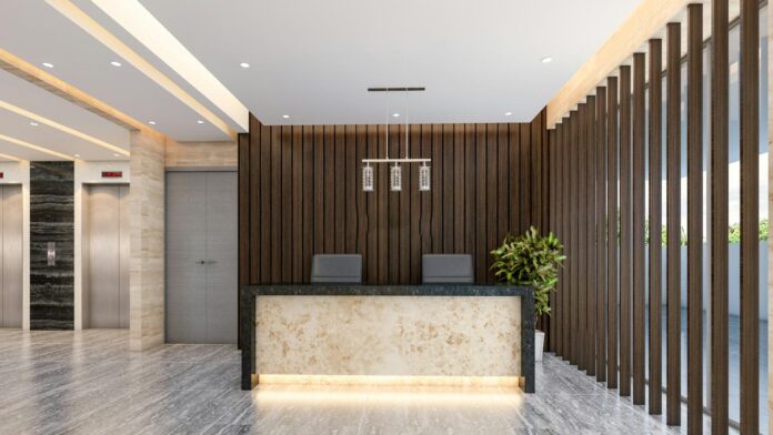 Lobi modern dengan meja resepsionis dan lift