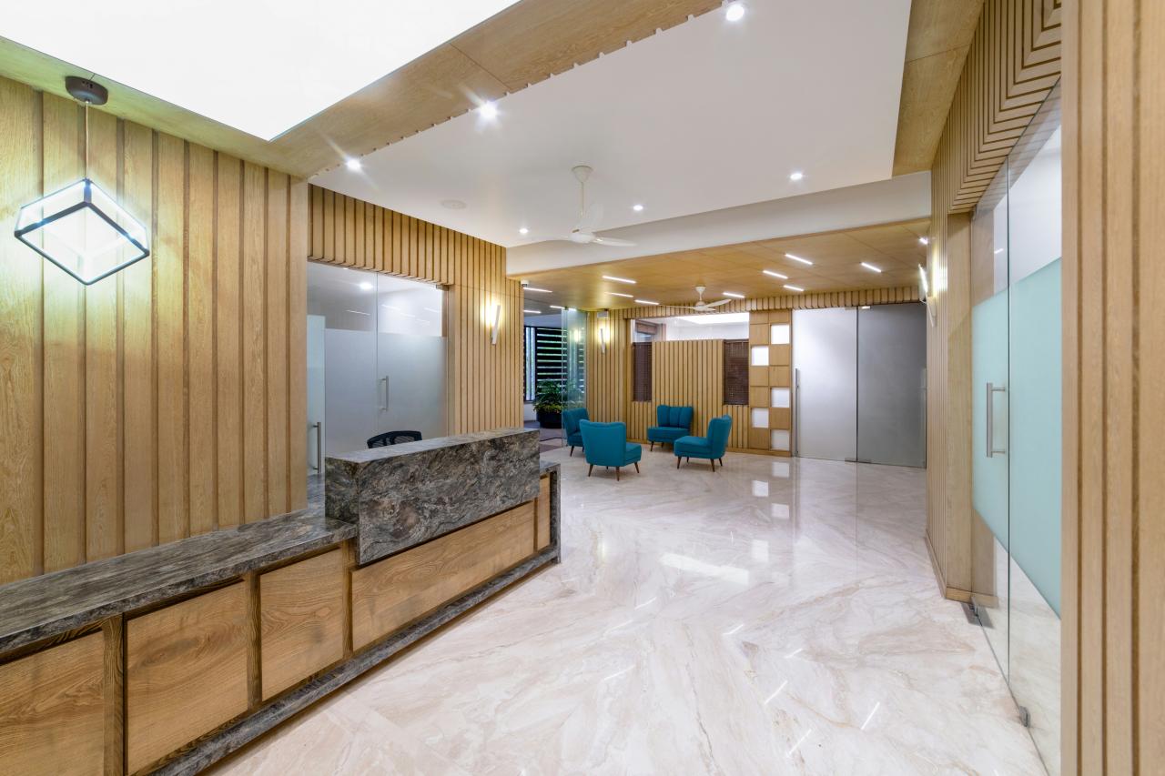 Lobi kantor yang elegan dengan resepsionis marmer.